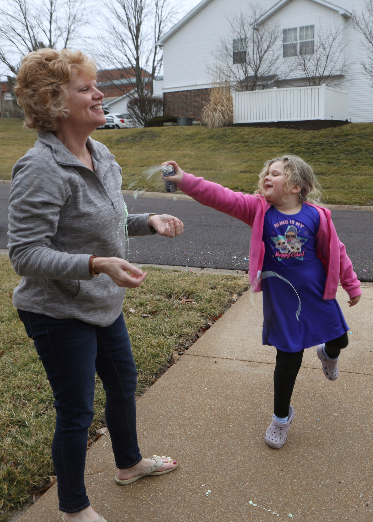 Norah Sadler sprays Kim Strubberg with silly string